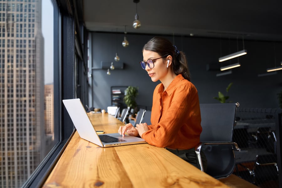 business woman at desk overlooking city