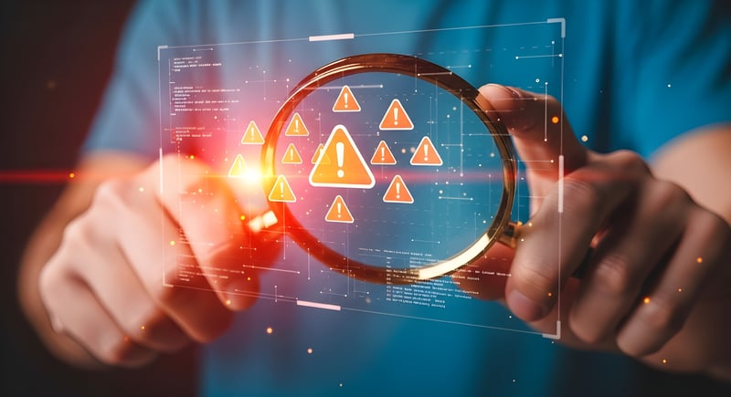 magnifying glass focusing on cyber red flags