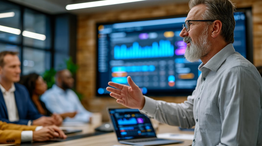 middle aged man presenting in a board meeting