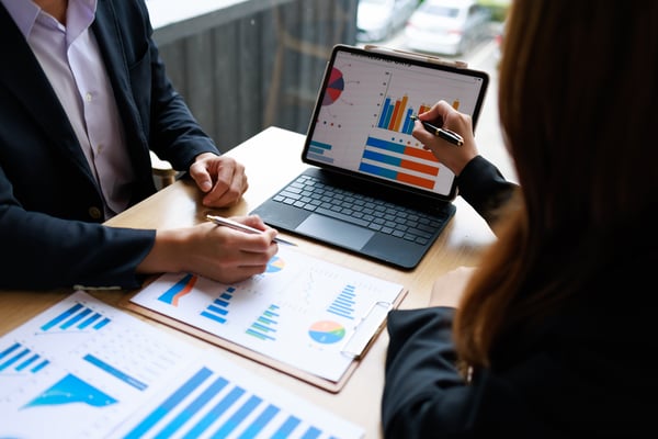 hands at desk of professional reviewing financial charts