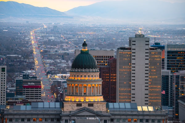 downtown salt lake city at dusk with view of capitol building and mountains