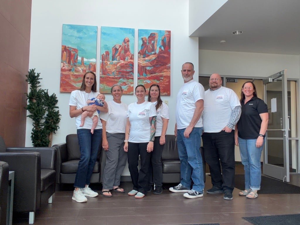 Larson employees in Moab office with July 4th thsirts