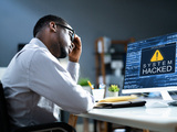person looked at a computer screen that has been hacked