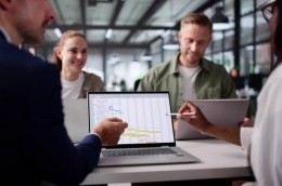 multiracial business professionals looking at a digital calendar