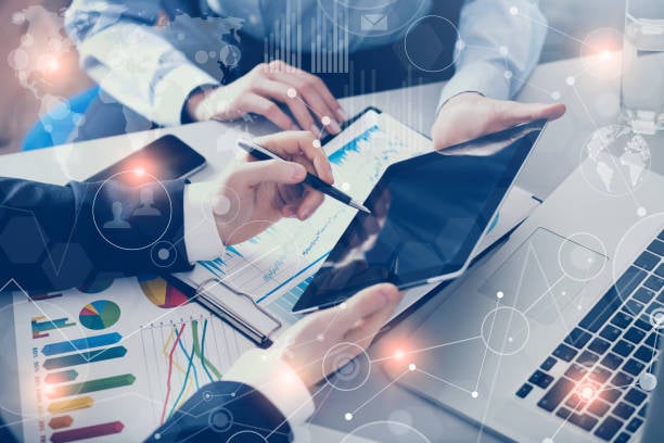 hands with screen device and papers