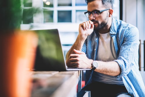 man looking at laptop screen