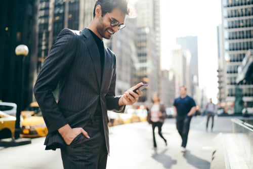 businessman in city look at phone