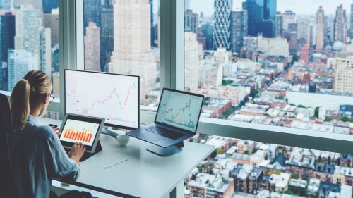back view of woman in office overlooking city