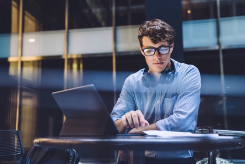 man at a desk with a laptop