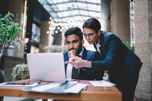 male and female looking at laptop screen