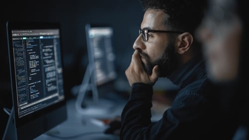 close up of man looking at computer screen