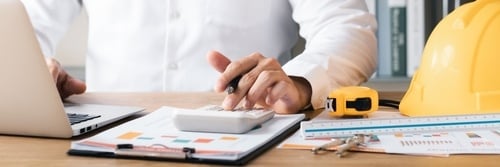 accountant at work with hard hat on the desk