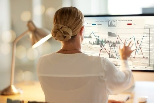 woman at her desk looking at computer screen