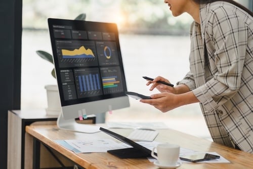 women looking a computer screen with charts