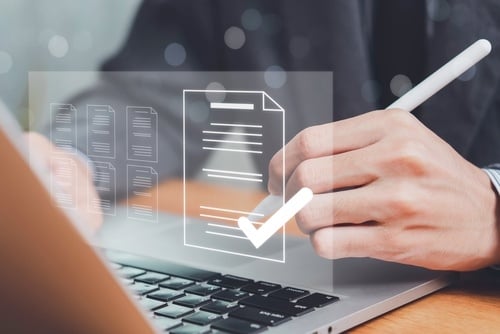 person viewing an electronic file icon on a laptop