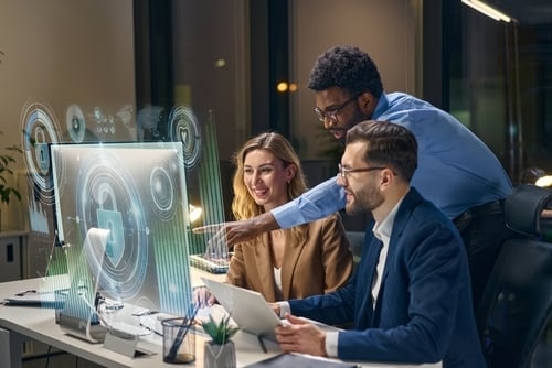team of professionals working on cybersecurity pointing to monitors