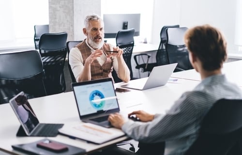 2 male business professionals meeting at a conference table 