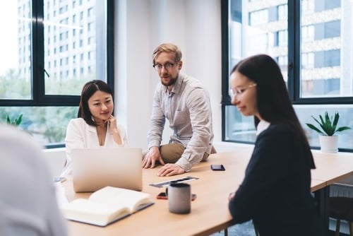 2 women and 1 man in a business meeting