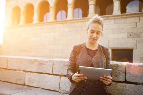 woman at museum looking at device