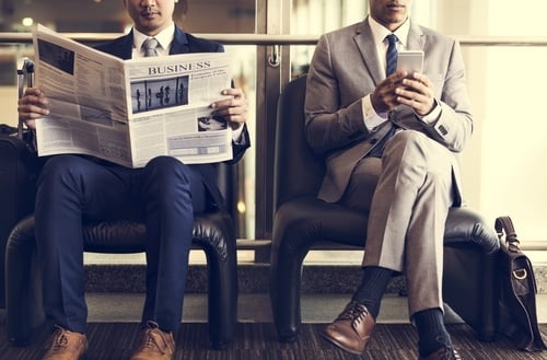 business people reading a newspaper