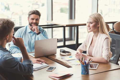 men and women in a business meeting at a conference table