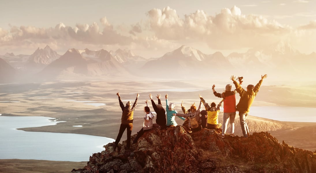 people celebrating a peak of mountain