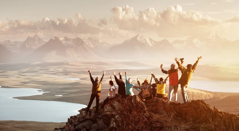 people celebrating a peak of mountain