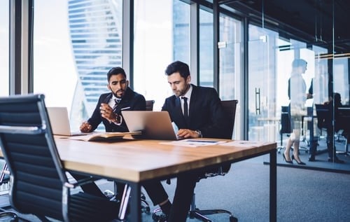 two business people at a desk working